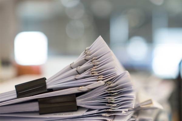 stackofpaperdocumentmanyjobswaitingtobe20231127050451utc_1.jpg